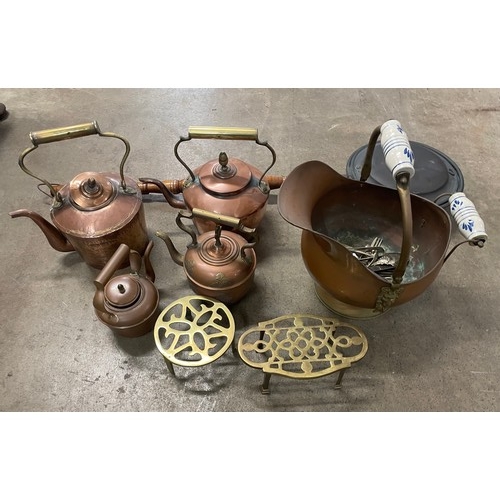 272A - A collection of metalware including a bed warming pan, two brass trivets, four copper kettles and a ... 