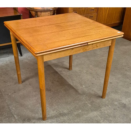 9 - A Danish teak draw leaf dining table