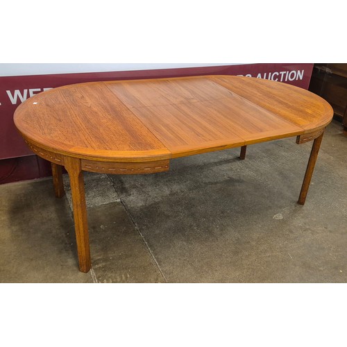 19 - A Danish teak extending dining table