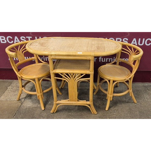 68 - An Italian style bamboo and rattan table and two chairs