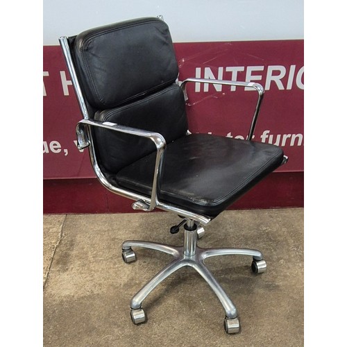 74 - An Eames style chrome and black leather revolving desk chair