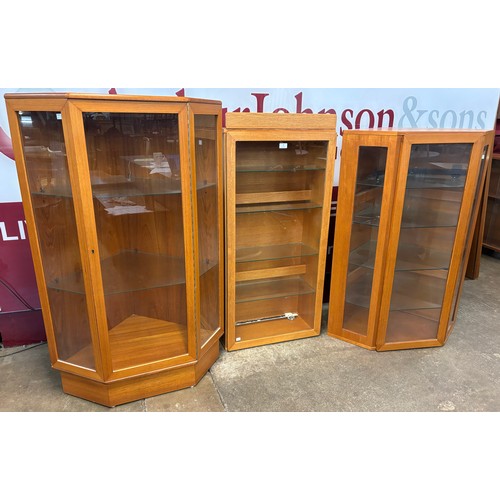 76 - Three Turnidge of London teak wall hanging display cabinets