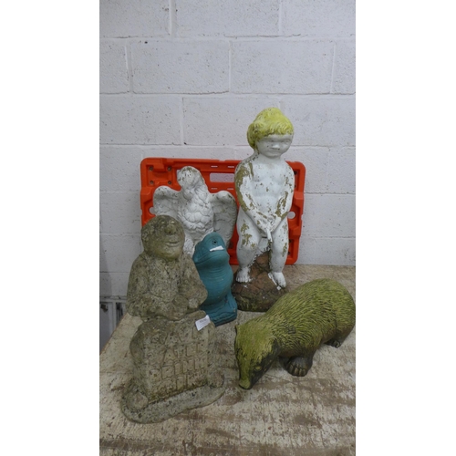 5218 - A collection of assorted concrete garden ornaments including, a badger, an eagle, a cherub, a frog a... 