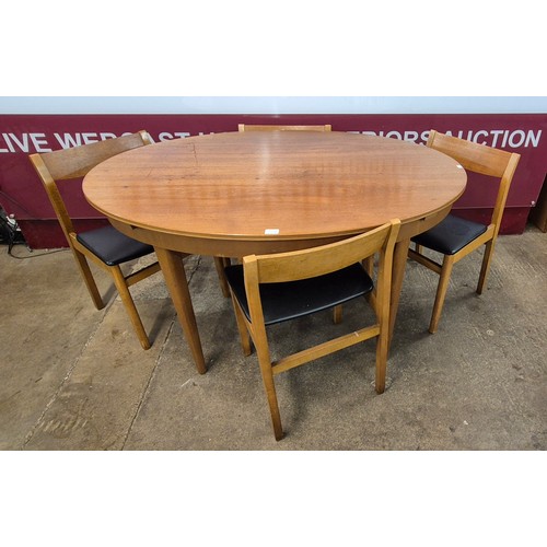 50B - A Greaves & Thomas teak oval extending dining table and four chairs