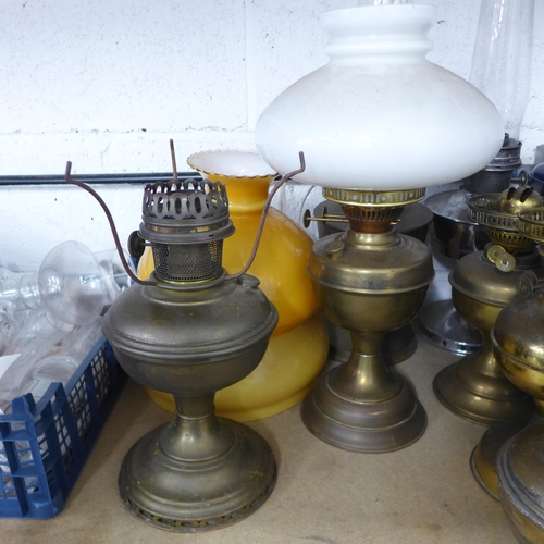 5041 - A collection of nine vintage pressure lamps and a quantity of assorted lamp glasses