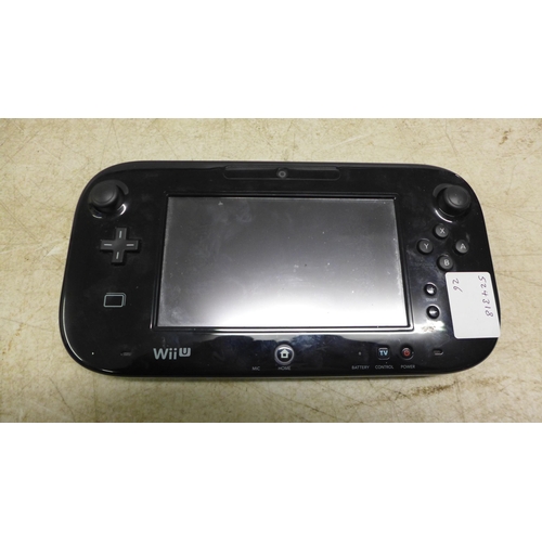 5052 - A Nintendo Wii U console with handheld Nintendo Wii U remote, one other Nintendo remote with nunchuc... 