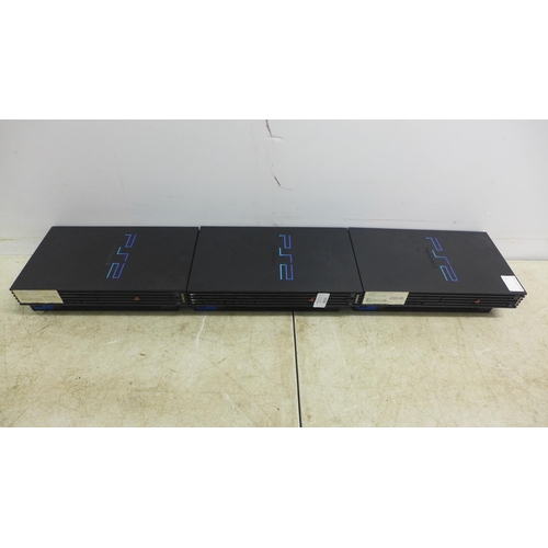 5058 - Three Playstation 2 consoles with two PlayStation controllers and two sets of power cables and AV ca... 