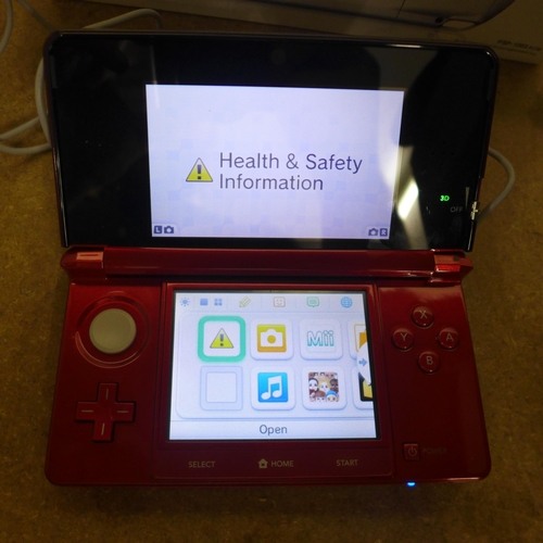 5086 - A Nintendo 3DS Metallic Red WAP-002 with charger and accessories in box, also includes a quantity of... 