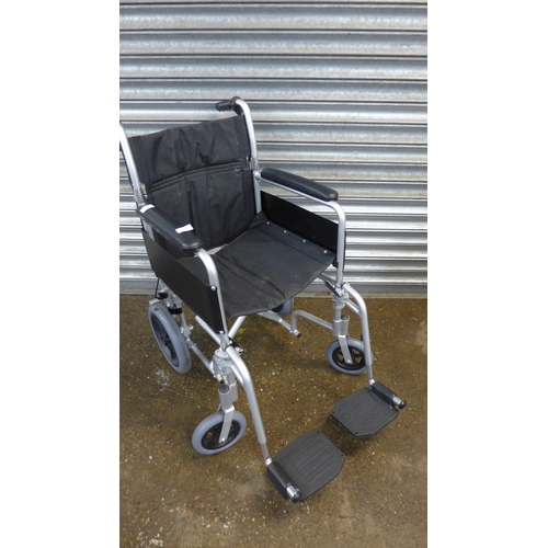 5236 - A Drive DeVilbiss operator driven wheelchair with footrests in black