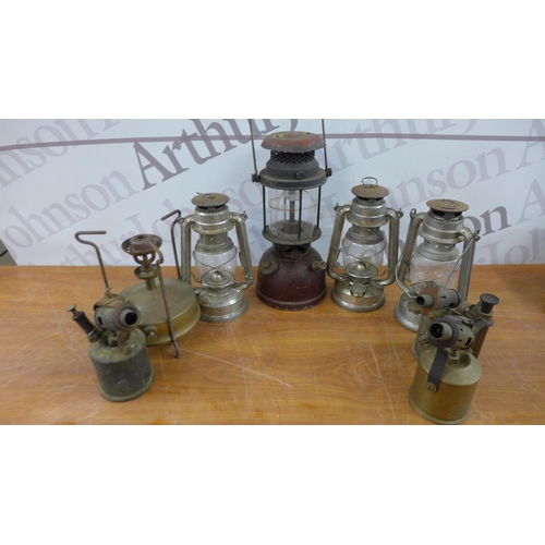 5254 - A collection of vintage blow lamps, pressure lamps and hurricane lanterns