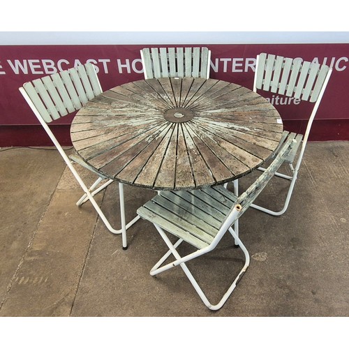 85 - A Danish Daneline teak and tubular metal circular garden table and four chairs