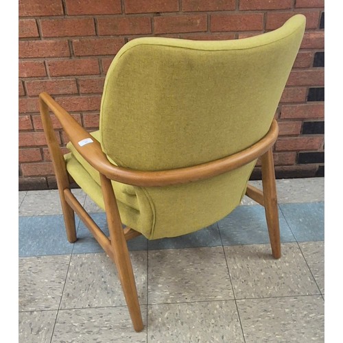 88 - A Danish style teak and green fabric armchair