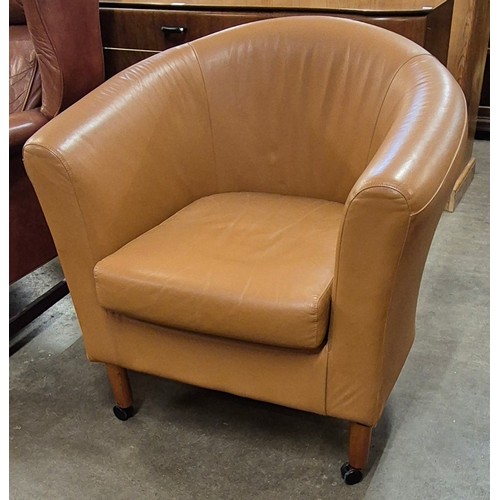 225 - A tan leather upholstered tub chair