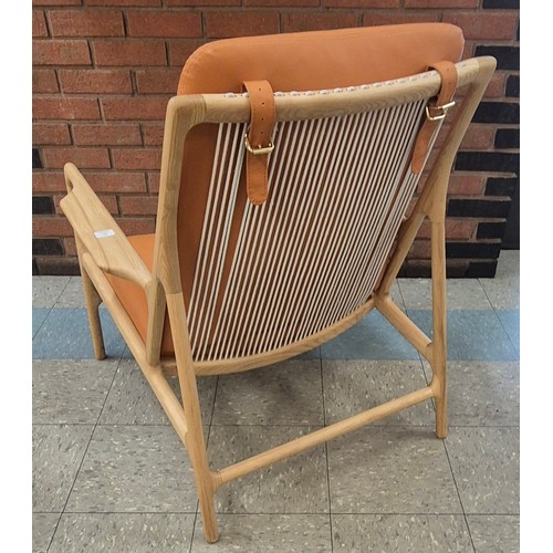 89 - A Danish style ash and tan vinyl armchair