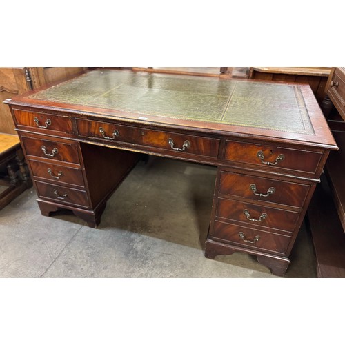 201 - A mahogany and green leather topped pedestal desk