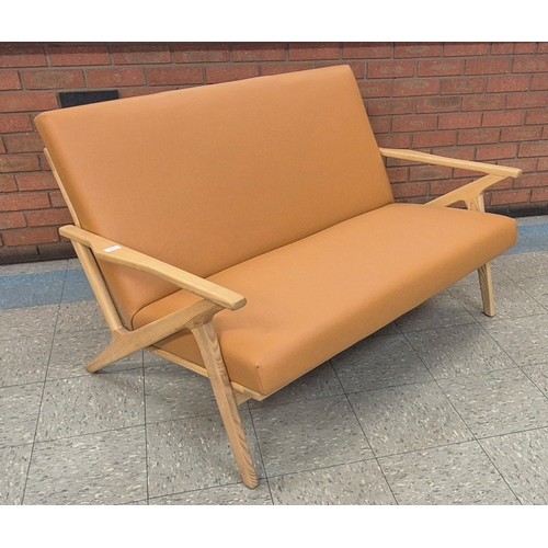 92 - A Danish style ash and tan vinyl sofa