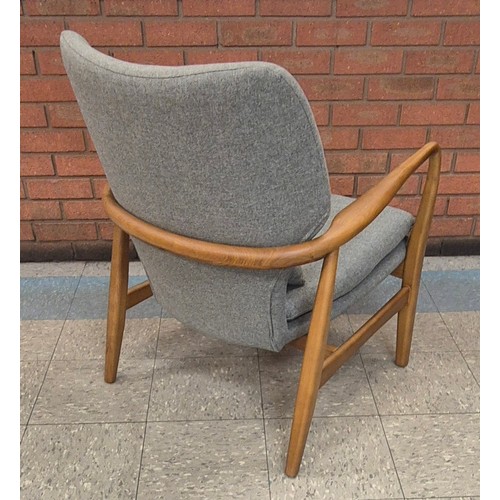 95 - A Danish style teak and grey fabric armchair