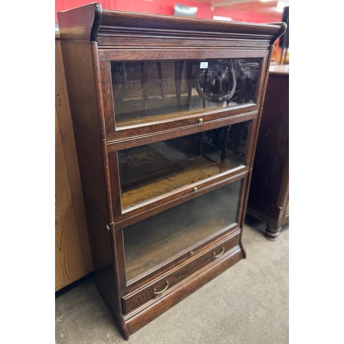 153 - An early 20th Century oak three tier sectional stacking bookcase