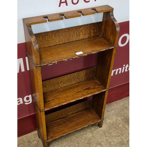 102 - An Arts & Crafts oak open bookcase/pipe stand