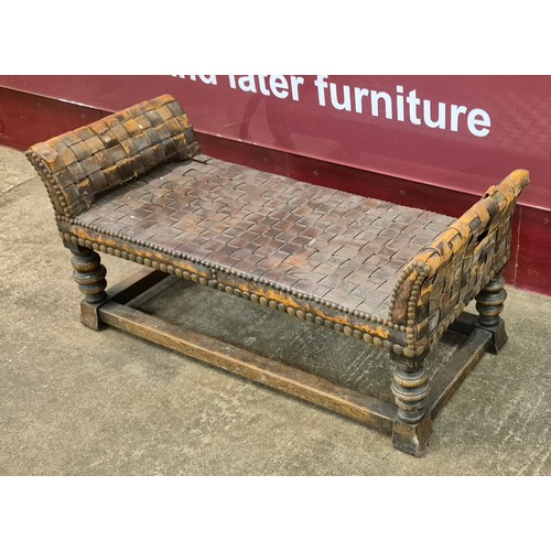 103 - An Arts & Crafts oak and leather window seat, attributed to Arthur Simpson