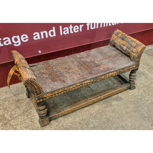 103 - An Arts & Crafts oak and leather window seat, attributed to Arthur Simpson