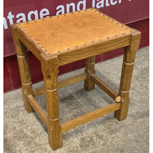 104 - An oak and tan leather stool, manner of Robert 'Mouseman' Thompson