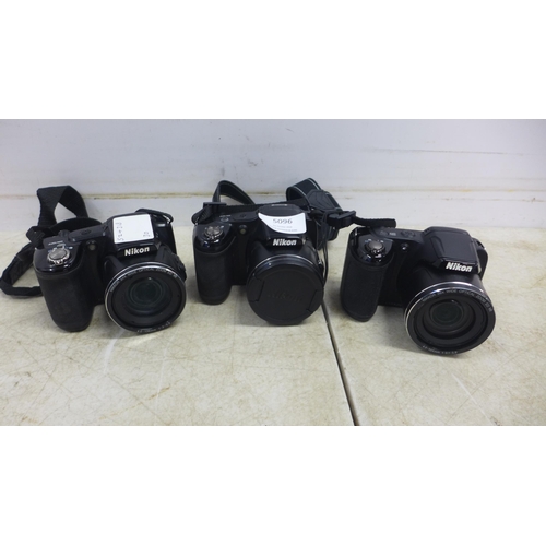 5096 - Three Nikon digital cameras including a Nikon Coolpix L830, a Nikon Coolpix L330 and a Nikon Coolpix... 