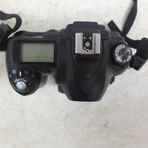 5098 - An Olympus E-1 digital camera and a Nikon D-50 digital camera - both sold with battery and charger