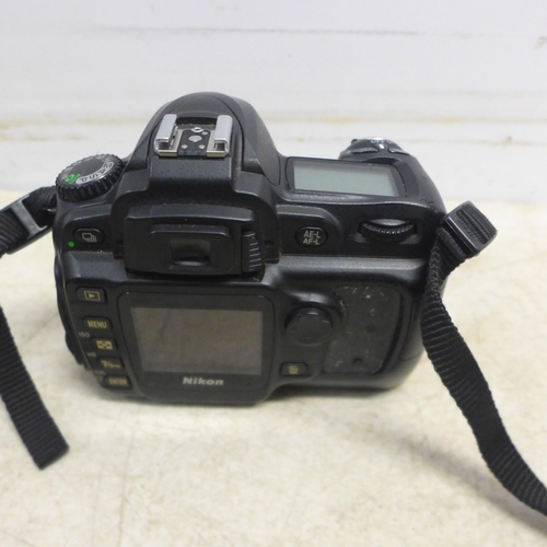 5098 - An Olympus E-1 digital camera and a Nikon D-50 digital camera - both sold with battery and charger