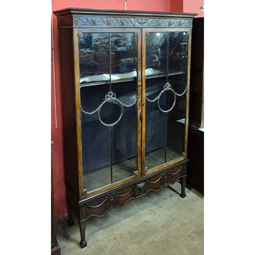 116 - An Edward VII Adams style carved mahogany two door bookcase