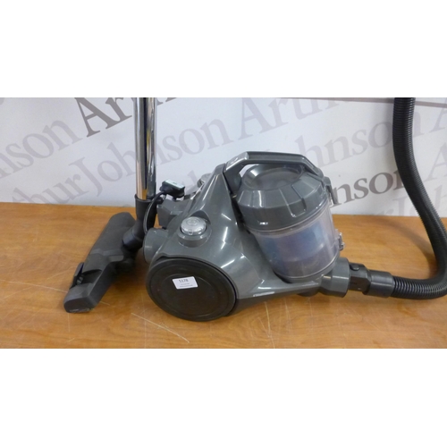 5178 - An Amazon basics cylinder vacuum cleaner with attachments