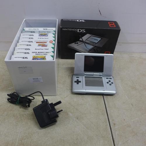 5111 - A Nintendo DS NTR-001 hand held gaming console with a box of 15 games