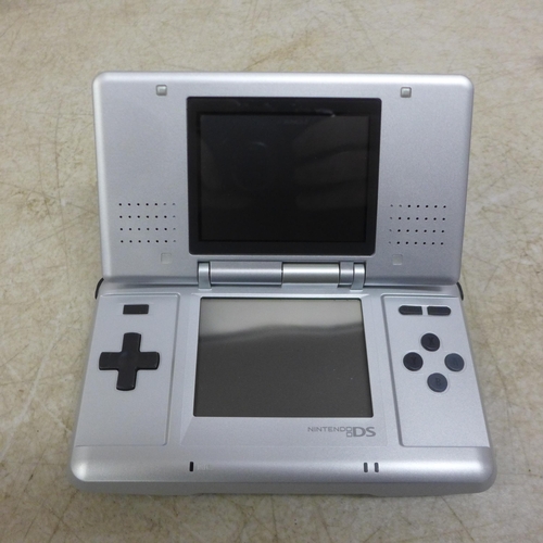 5111 - A Nintendo DS NTR-001 hand held gaming console with a box of 15 games