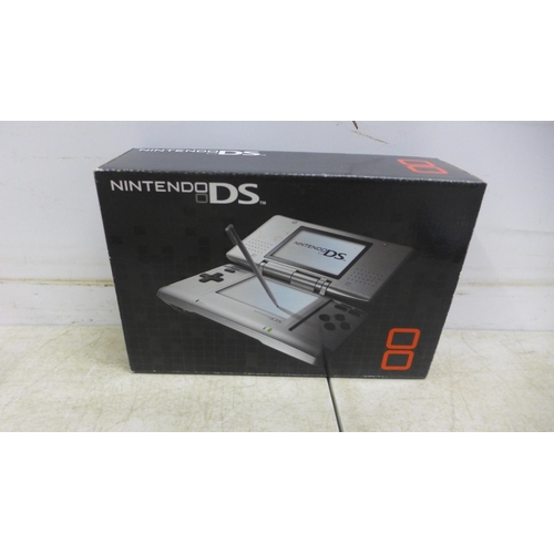 5111 - A Nintendo DS NTR-001 hand held gaming console with a box of 15 games