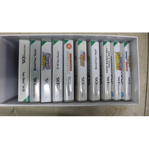 5111 - A Nintendo DS NTR-001 hand held gaming console with a box of 15 games