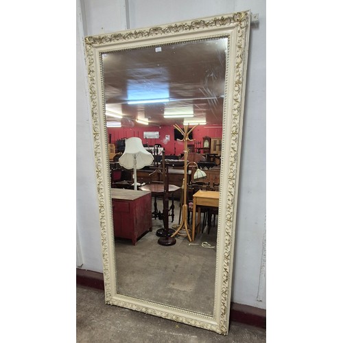 123 - A large Victorian cream and parcel gilt framed shop mirror