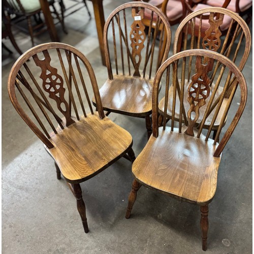 203 - A set of four early 20th Century beech wheelback kitchen chairs