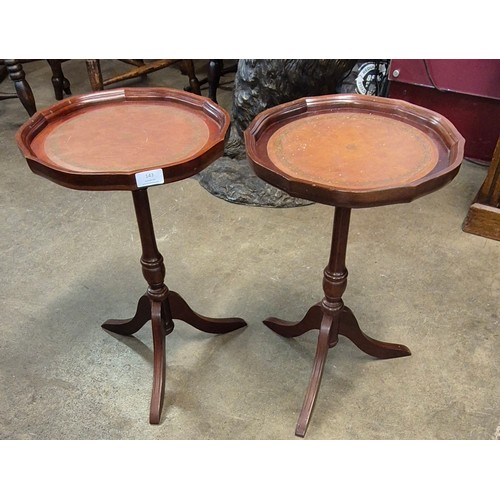 143 - A pair of Regency style mahogany and brown leather topped wine tables