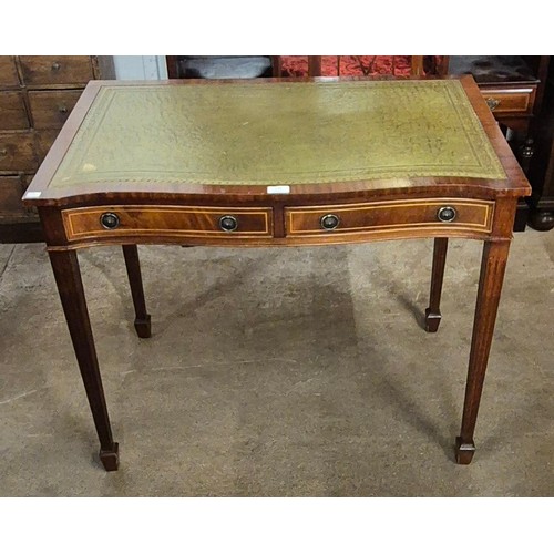 144 - A Regency style inlaid mahogany and green leather serpentine writing desk