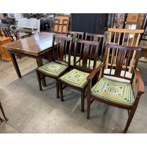 231 - An early 20th century oak extending dining table, a set of five dining chairs and with Scandinavian ... 