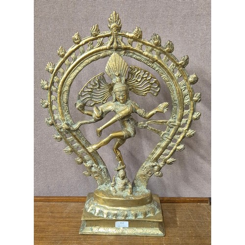 353 - A large eastern brass figure of dancing Shiva and five small brass figures of deities