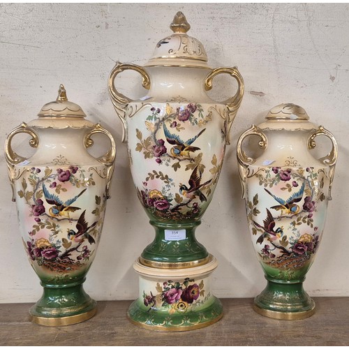 354 - An early 20th Century painted porcelain two handled vase and a pair of garnitures