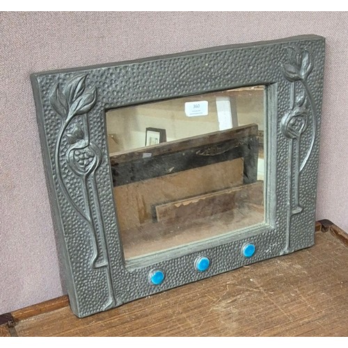 360 - An Arts & Crafts style pewter effect framed mirror, set with three Ruskin style cabochons