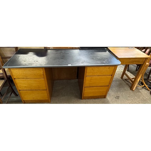 242 - A beech school desk and an oak pedestal desk