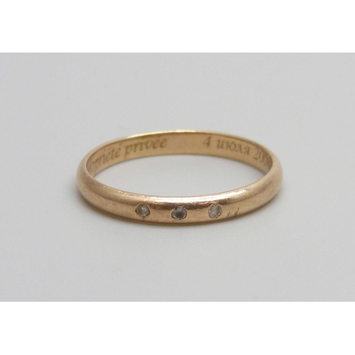 1000 - A 14ct gold ring set with three white stones, inscription inside shank, 1.5g, L