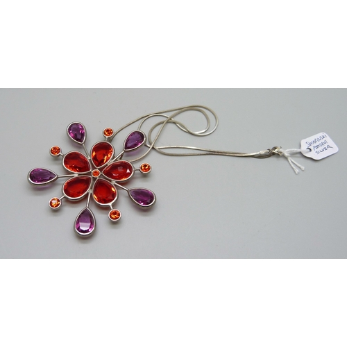 1006 - A Swarovski red crystal pendant on a silver chain, 6cm