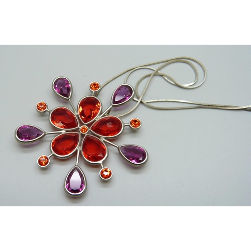 1006 - A Swarovski red crystal pendant on a silver chain, 6cm