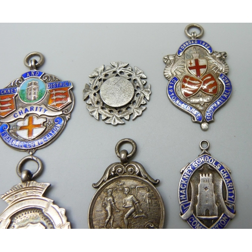 1039 - A collection of 12 silver and enamel football fobs, 121g, together with four others