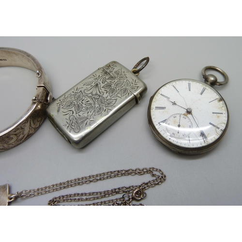 1050 - A silver bangle, 26g, a white metal pocket watch, a plated vesta case, and a silver 'R' pendant on a... 