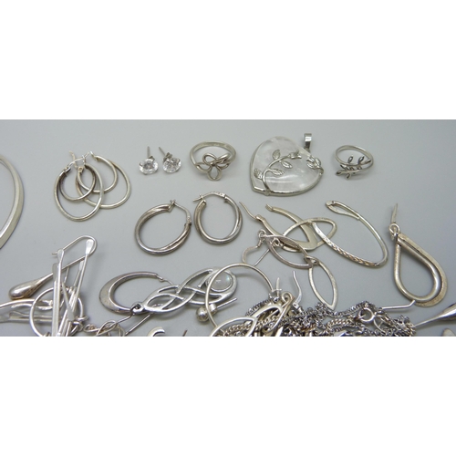 1058 - A collection of silver, white metal and plated jewellery, mostly earrings, together with a silver ba... 